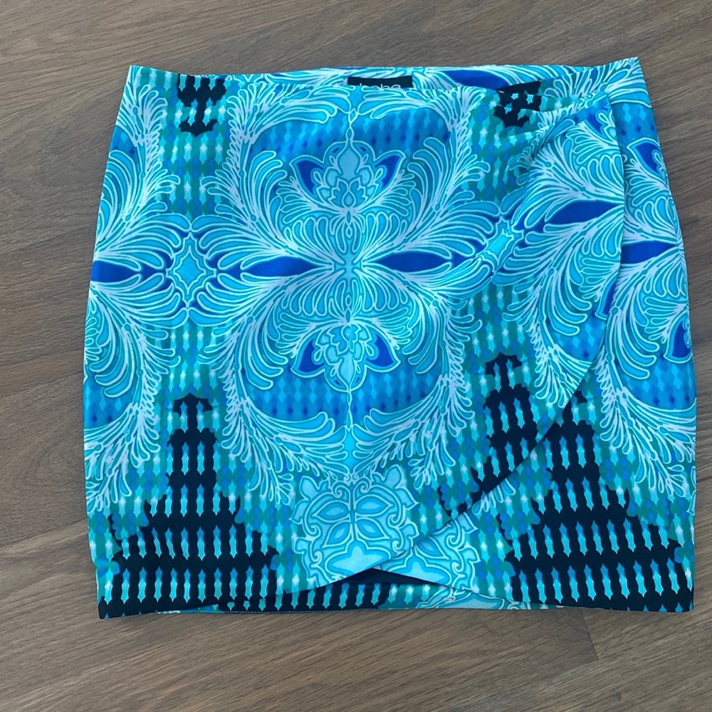 Bebe mini wrap skirt with button and snap closure
